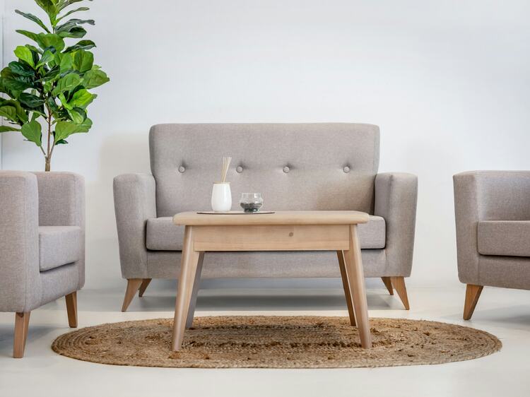A clean grey upholstered sectional in a sunlit residential interior